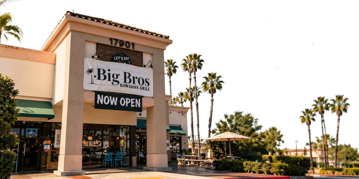Big Bros Hawaiian Grill restaurant exterior with its sign and palm trees